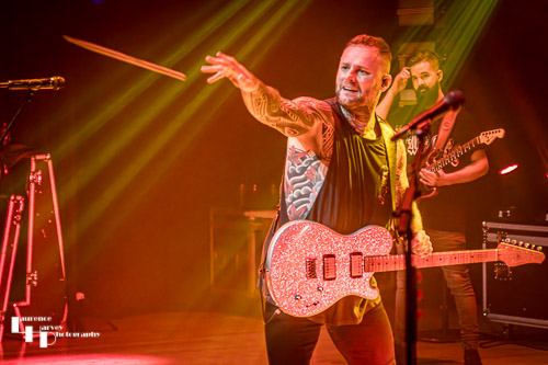 Kris Barras throwing souvenir drumstick into the crowd