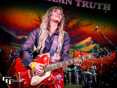 Megan Kane on guitar & vocals.