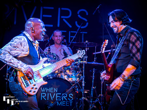 Aaron Bond on guitar, Roger Innis on bass, James Fox on drums