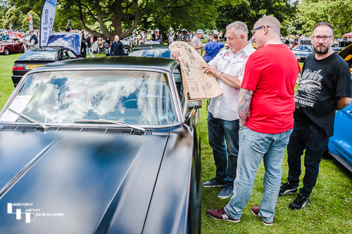 Owner of classic American car with newspaper from the year it was made