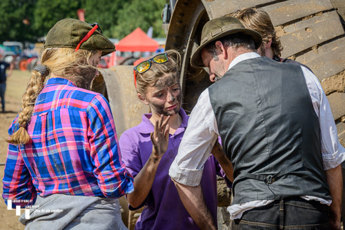 Candid of girls re-enacting farm workers during traction engne era